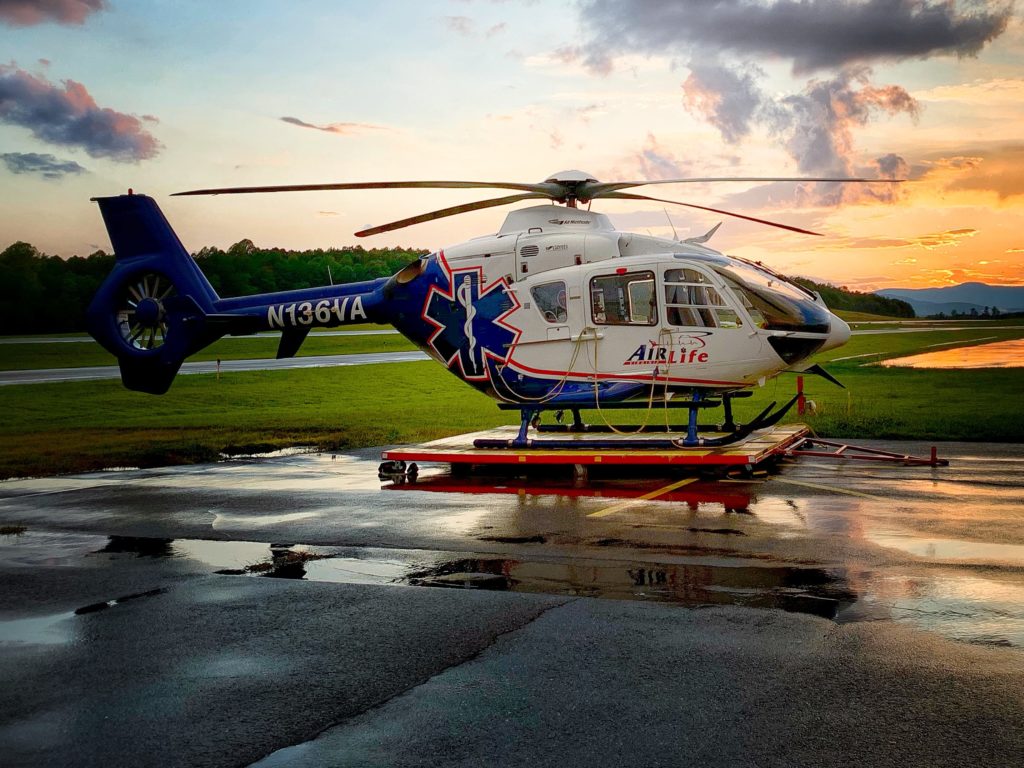 air medical helicopter with sunset in background after rain