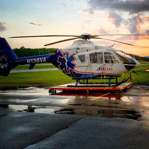 air medical helicopter with sunset in background after rain