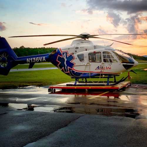 air medical helicopter with sunset in background after rain
