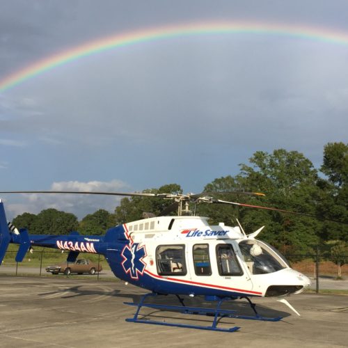 air medical helicopter with rainbow in the background