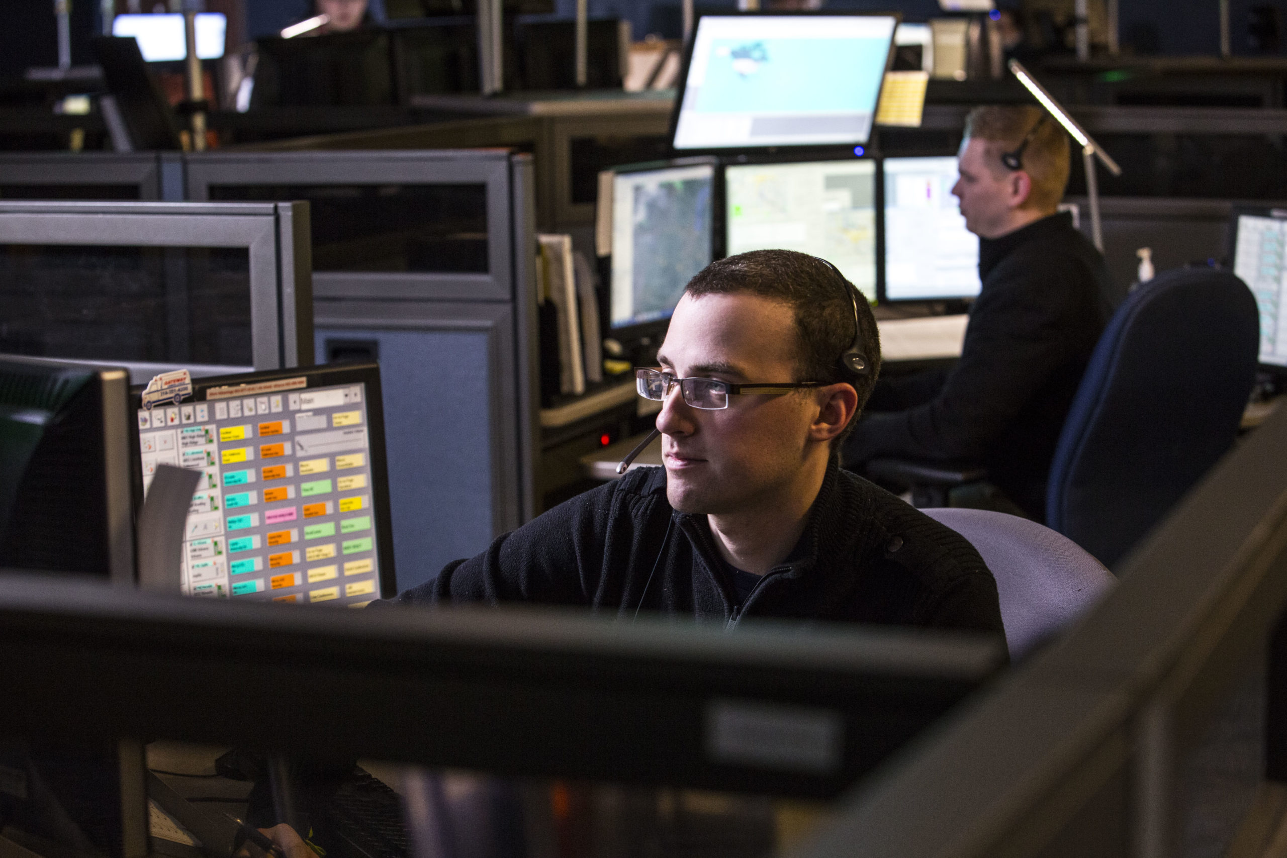 Air Methods dispatch employee sitting at desk.