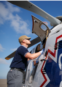 Mechanic working on helicopter. 