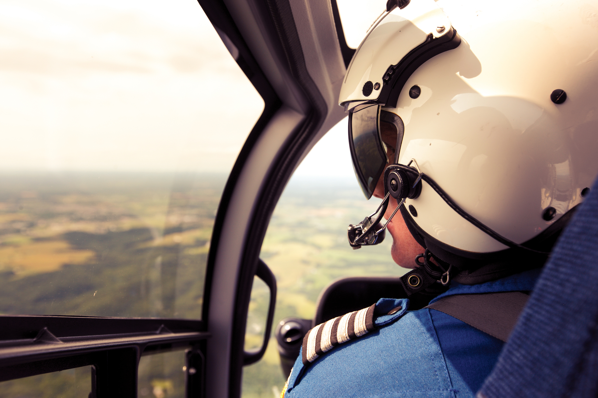 Helicopter pilot in cockpit. 