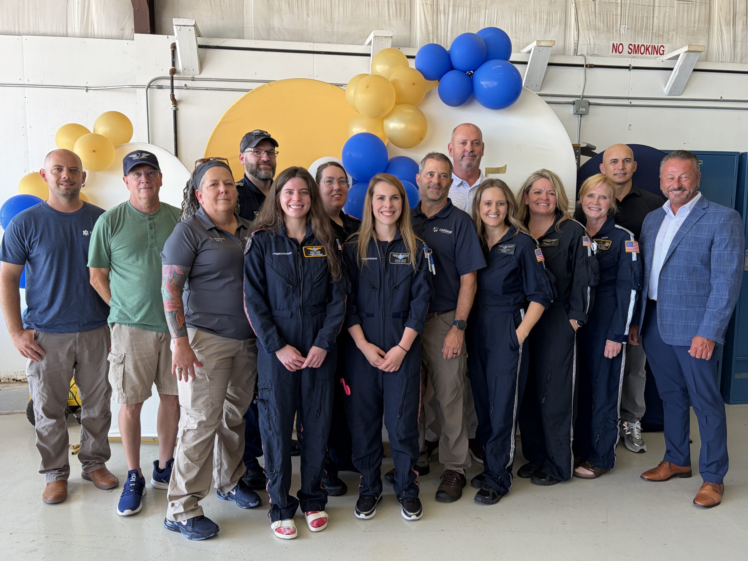 LifeSave crew stands in front of balloons for group photo