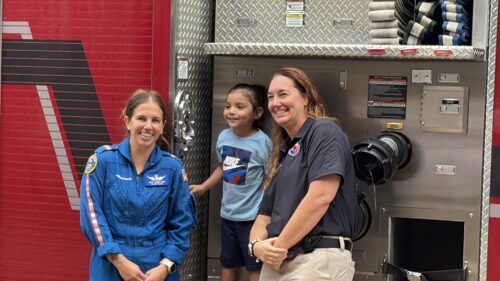 AirLIFE TEXAS crew members and patient in front of fire truck