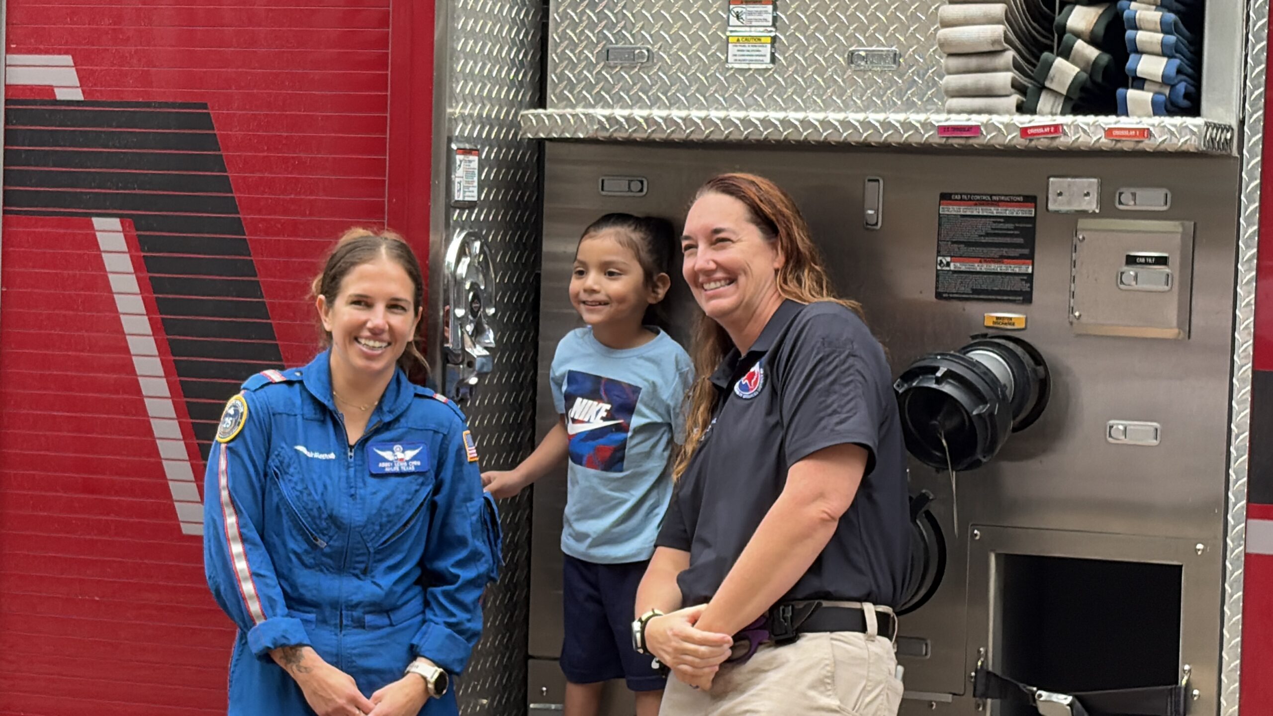 AirLIFE TEXAS crew members and patient in front of fire truck